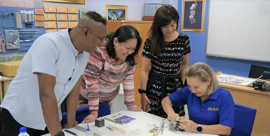 Silver clay students looking at instructor Tanja